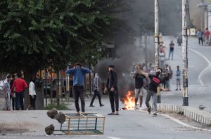Kashmiri residents throw stones towards Indian security forces during restrictions after the scrapping of the special constitutional status for Kashmir by the government, in Srinagar